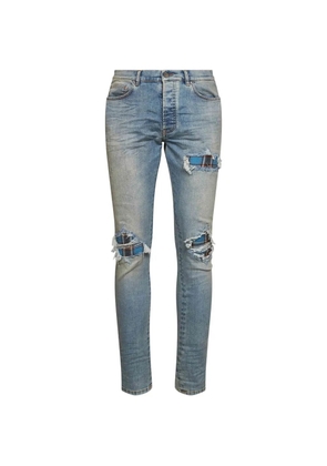 AMIRI distressed-effect patched jeans - Blue