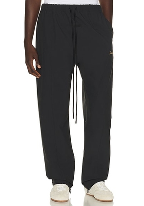 Fear of God ESSENTIALS Signature Track Pant in Vintage Black - Black. Size XS (also in S, M, L, XL/1X, XXL/2X, XXXL/3X).