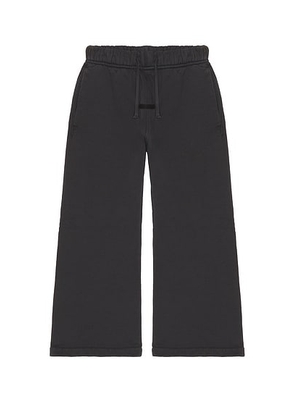 Fear of God ESSENTIALS Kids Signature Flare Sweatpant in Faded Black - Black. Size 4/5 (also in 2/3, 6/7).