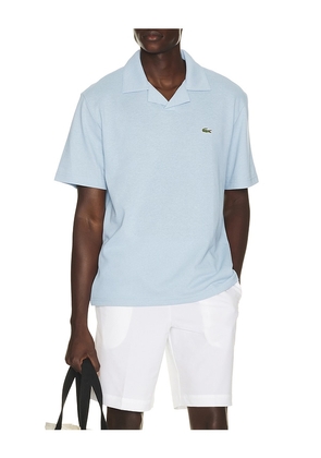 Lacoste Polo in Denim-Dark. Size 3. Also in 6, 4, 5, 7.
