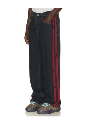 Nahmias Destroyed Denim Track Pant in Blue. Size 30. Also in 32, 34, 36, 38.