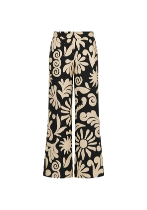 Cala de la Cruz Toya floral-print trousers - Black