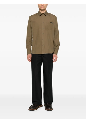 Prada pressed-crease logo-plaque trousers - Black