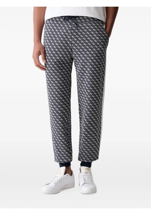 GUESS USA monogram-print side-stripe track pants - Blue