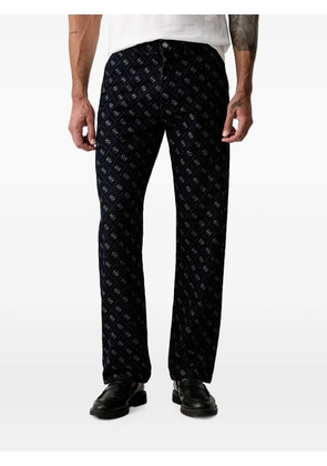 GUESS USA Damon monogram-print logo-patch jeans - Blue
