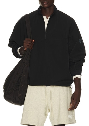 Fear of God ESSENTIALS Half Zip Track Jacket in Vintage Black - Black. Size XXXL/3X (also in XS, S, M, L, XL/1X, XXL/2X).