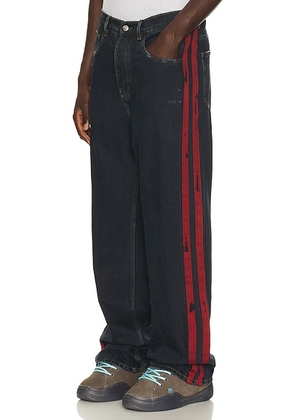 Nahmias Destroyed Denim Track Pant in Dark Indigo Wash - Blue. Size 34 (also in 30, 32, 36, 38).