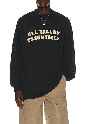 Fear of God ESSENTIALS Merch Long Sleeve Tee in Vintage Black - Black. Size XS (also in S, M, L, XL/1X, XXL/2X).