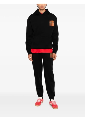 Melt graphic-print track pants - Black