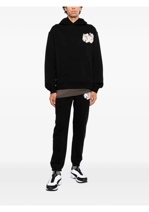 Melt tiger-patch track pants - Black